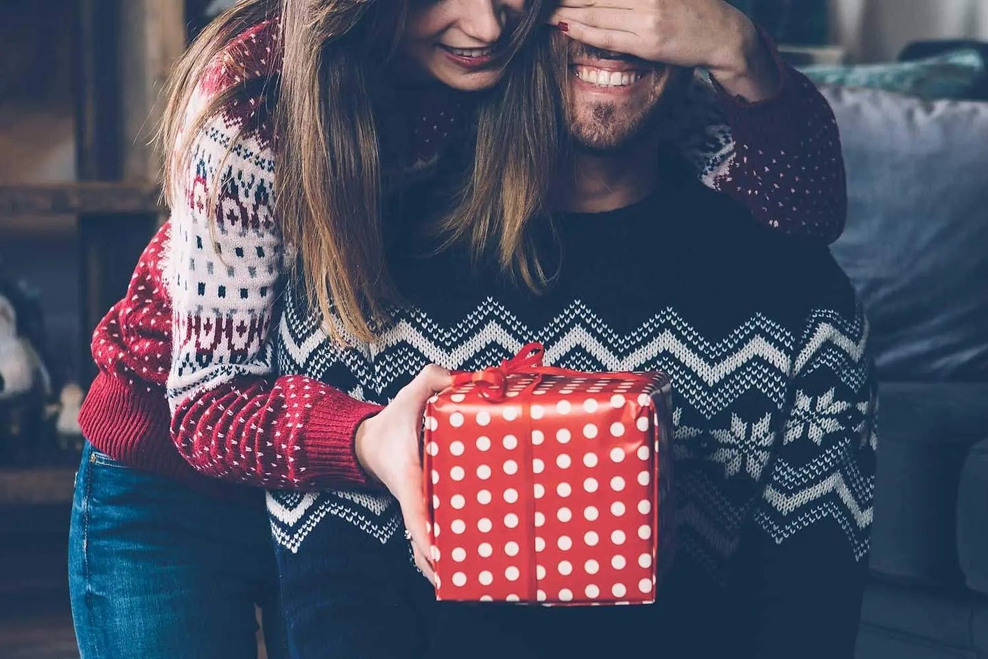 a couple exchanging christmas gifts